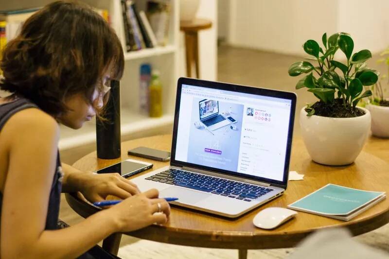Student doing homework on a laptop at a desk, representing back-to-school laptop setup and parental controls