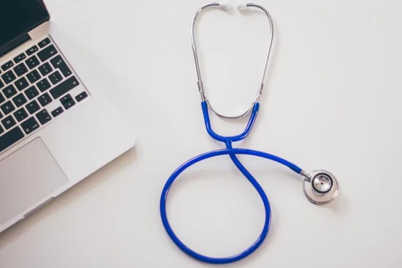 Stethoscope beside a laptop computer, representing HIPAA IT compliance and patient data security for small medical practices