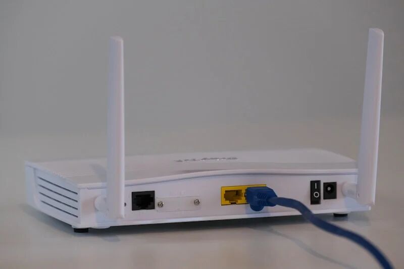 Home wireless router with network security settings configured to protect all household devices from cyber threats