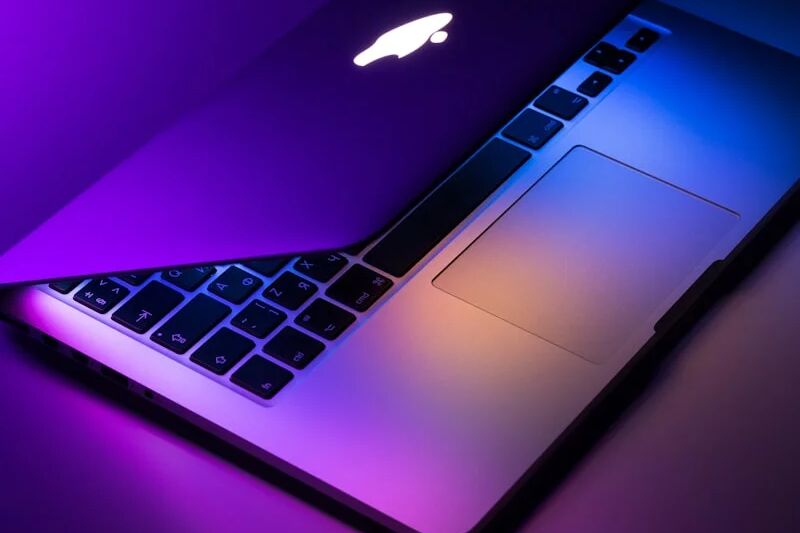 Apple Mac and Windows PC computers side by side representing a mixed operating system business environment