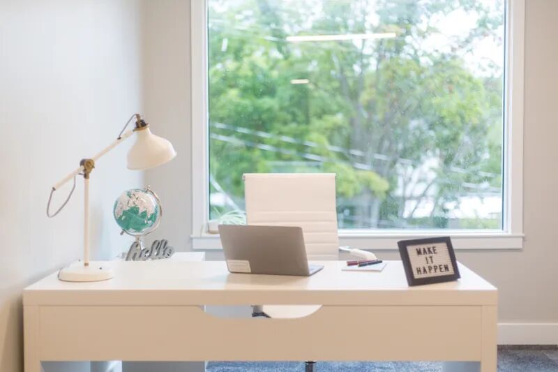 Bright home office with a laptop on a desk, representing reliable whole-home mesh Wi-Fi coverage in an Albuquerque house