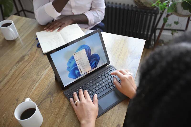Microsoft 365 Copilot AI assistant interface on a laptop helping draft emails and summarize documents