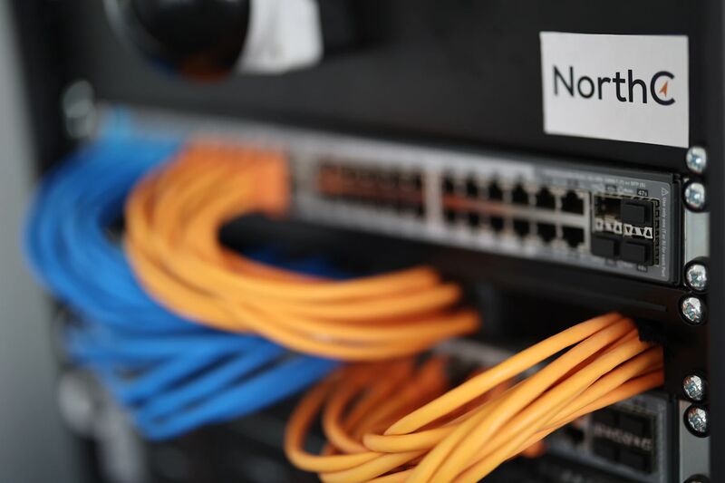 Structured Cat6 network cabling with a labeled patch panel installed in an Albuquerque office network room